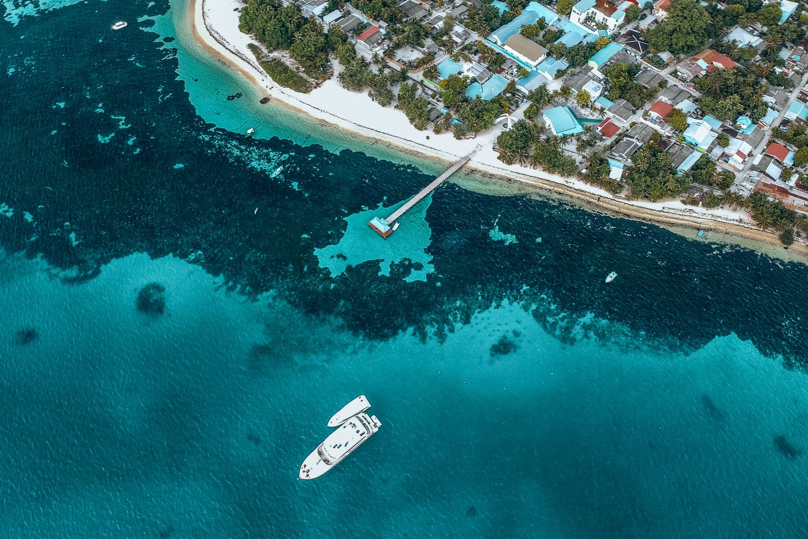 Aerial photography of a ship leaving its port with the [urpose of going and finding new adventures
